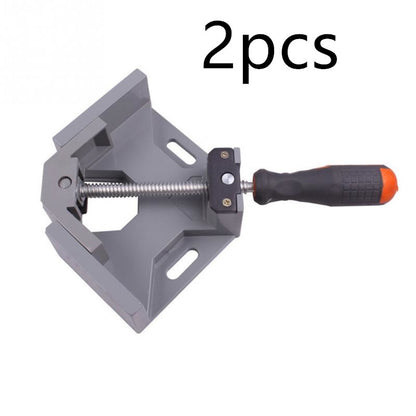 Gray corner clamp with black and orange handle on a white background, labeled '2 pcs'.