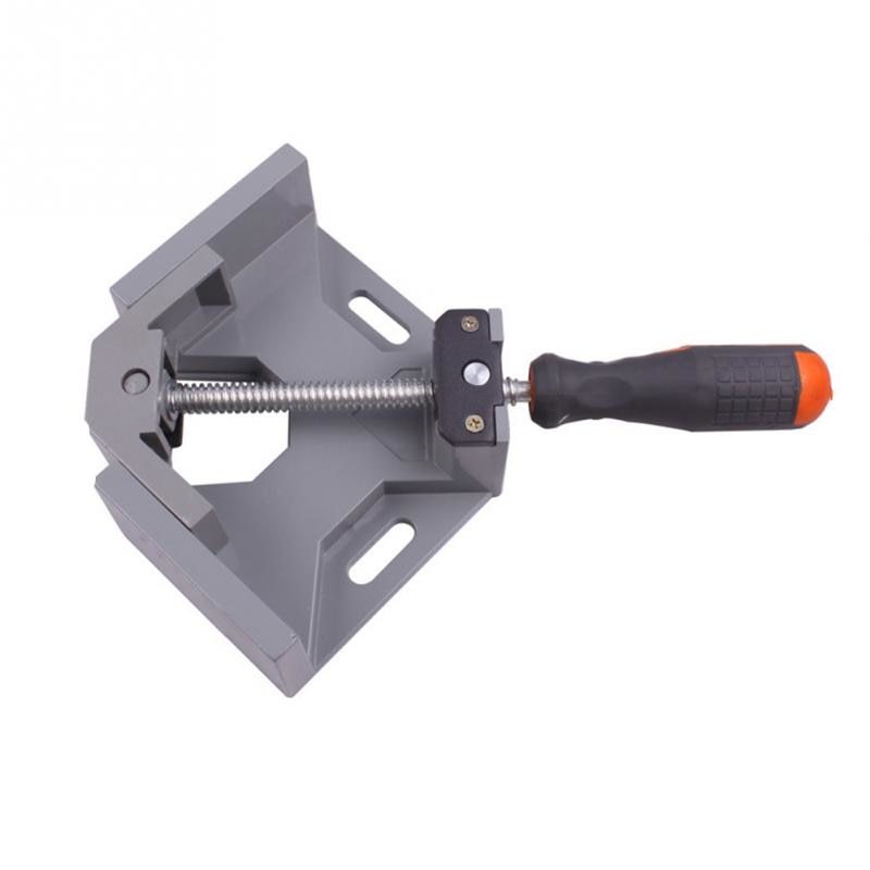 Corner clamp with gray body and black handle on a white background